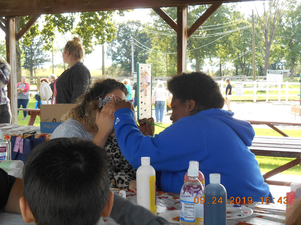 ECE Students doing face painting of preschoolers.